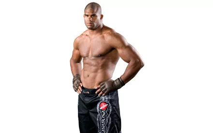 A muscular kickboxer stands confidently, showcasing strength and determination in this high-definition wallpaper, celebrating the spirit of MMA and martial arts through Alistair Overeem's impressive physique.