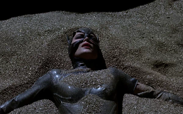 Catwoman from Batman Returns lying in glittering sand, glossy black suit and mask — HD PC desktop wallpaper/background.