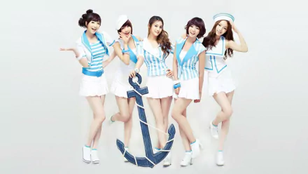 HD PC desktop wallpaper of a Korean K-pop music girl group in matching sailor outfits posing around a large navy anchor on a bright, minimal background.