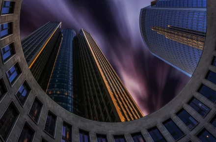 View from below of Tower 185 skyscraper in Frankfurt, Germany, with dramatic evening sky, showcasing modern man-made architecture in an HD desktop wallpaper style.