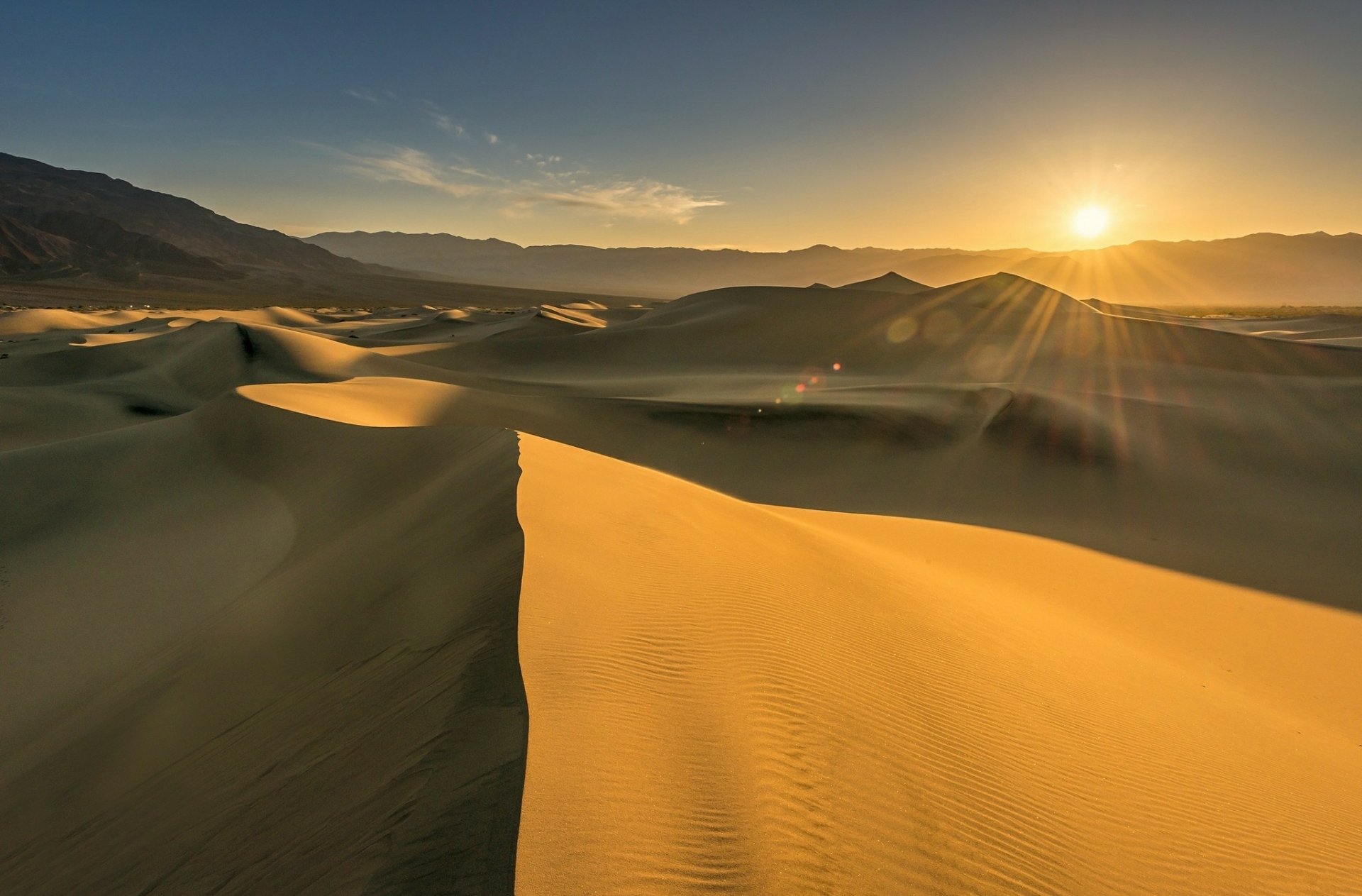 Sunshine illuminates vast sand dunes in a desert landscape, capturing the natural beauty of the scene in this HD PC desktop wallpaper and background.