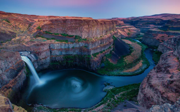 A stunning HD wallpaper of Palouse Falls cascading into the Palouse Canyon at Palouse Falls State Park, Washington, showcasing vibrant natural beauty and rugged terrain.