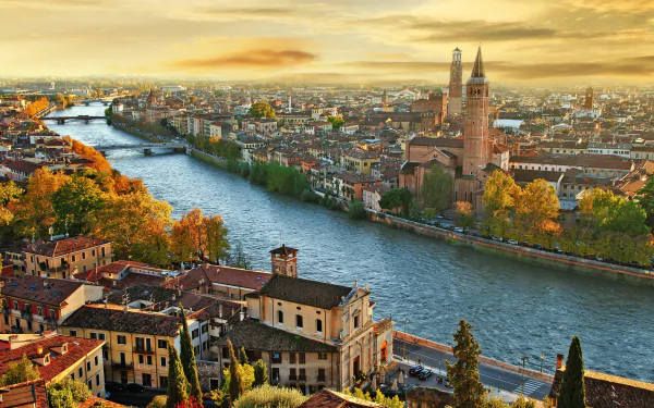 Autumn sunset over the historic city of Verona, Italy, showcasing its river and iconic architecture in a vibrant HD desktop wallpaper.