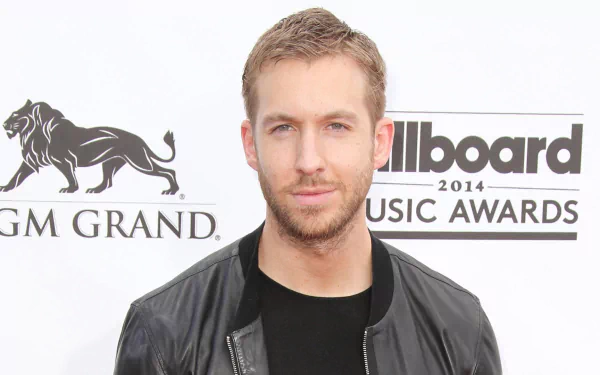 HD desktop wallpaper featuring Calvin Harris at the 2014 Billboard Music Awards, showcasing his signature style and charisma in a dynamic music-themed backdrop.