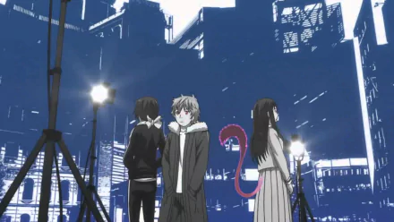 HD wallpaper featuring Yato, Yukine, and Hiyori from 'Noragami' against a blue cityscape background.