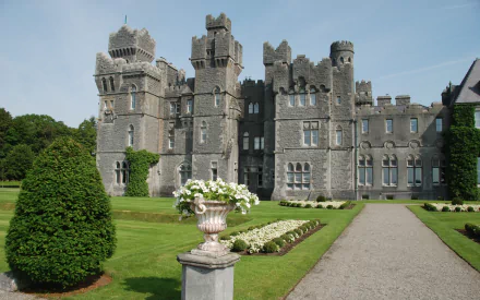 Ashford Castle, man-made gray stone Gothic revival castle with manicured gardens and a central pathway, HD PC desktop wallpaper background