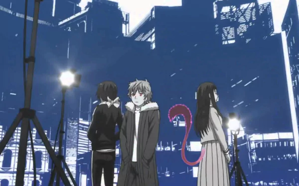HD wallpaper featuring Yato, Yukine, and Hiyori from 'Noragami' against a blue cityscape background.