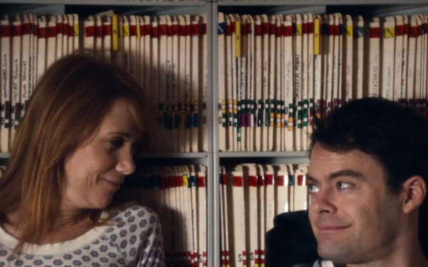 HD desktop wallpaper from The Skeleton Twins featuring a smiling woman and a man in front of a bookshelf.