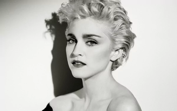 A black and white HD desktop wallpaper featuring Madonna, showcasing her striking features and iconic hairstyle against a contrasting background.