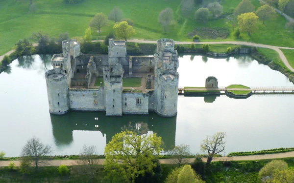 Aerial view of Bodiam Castle surrounded by a moat, showcasing its medieval architecture and lush greenery, captured in HD for a desktop wallpaper background.