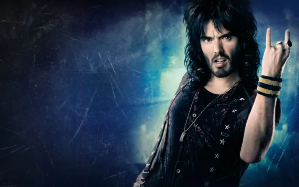 HD desktop wallpaper featuring Russell Brand as a character from the movie Rock of Ages, striking a rock hand gesture against a textured blue background.