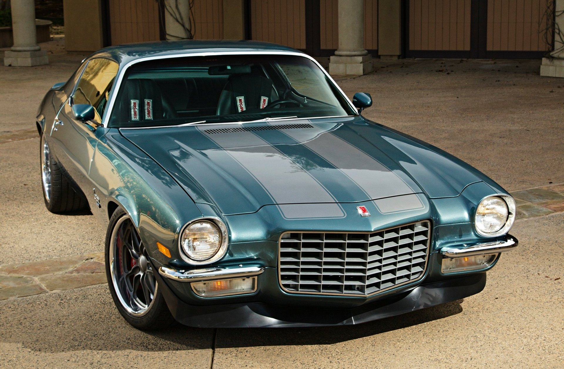 HD desktop wallpaper featuring a classic Chevrolet Camaro parked on a stone pavement, showcasing its sleek design and vintage charm.