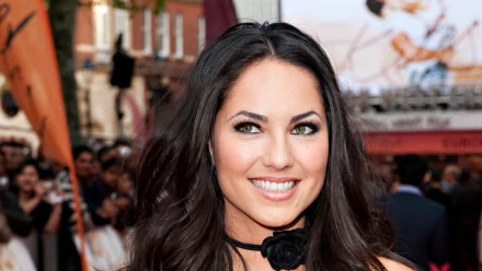 Barbara Mori, a renowned Mexican actress, smiles warmly amid a vibrant crowd, captured in a stunning HD desktop wallpaper that radiates charm and charisma.