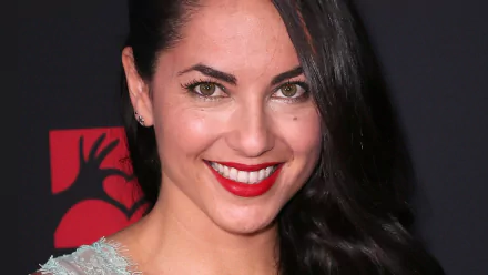 A vibrant HD desktop wallpaper featuring Mexican actress Barbara Mori, showcasing her radiant smile and elegant style against a striking background.