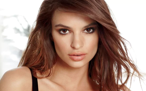 HD desktop wallpaper featuring American model and celebrity Emily Ratajkowski with flowing hair and a striking gaze.