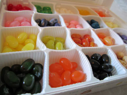 Close-up of a colorful assortment of jelly beans neatly organized in a box, captured as an HD PC desktop wallpaper and background.