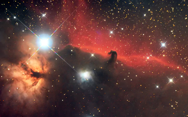 4K Ultra HD PC desktop wallpaper — Sci‑Fi nebula: vivid crimson gas clouds, a dark horsehead silhouette and bright, glittering stars scattered across deep space.