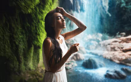 HD desktop wallpaper featuring a serene scene of a waterfall with a woman, model Mary Senn, posing gracefully in a white dress. The lush greenery and cascading water create a tranquil background.