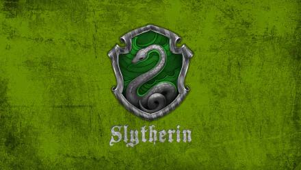 HD desktop wallpaper featuring the Slytherin crest from the Harry Potter movie series. The crest shows a silver snake on a green textured background with the word 'Slytherin' below it.