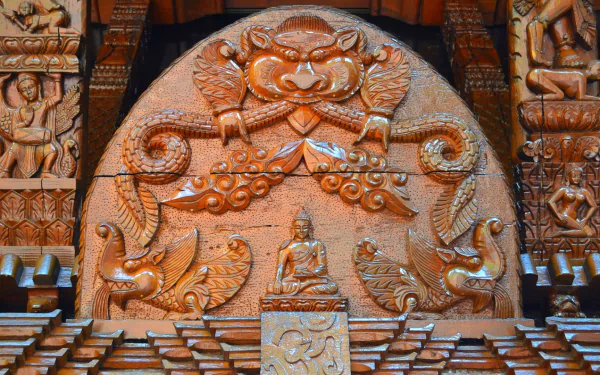 HD photography of a man-made Nepalese pagoda wood carving in Brisbane, close-up of Buddha figure and ornate guardian motifs — PC desktop wallpaper/background.