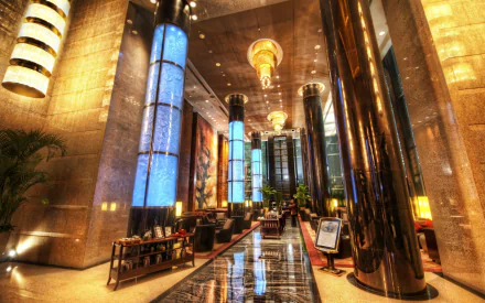 Grand Millenium Hotel lobby, Beijing, China — opulent man-made interior with tall glossy columns, blue illuminated pillars and chandeliers. 5K Ultra HD PC wallpaper.