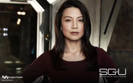 HD wallpaper featuring Ming-Na Wen as Camille Wray from the TV show Stargate Universe, showcasing her poised expression in a sci-fi setting.