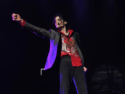 Michael Jackson performing on stage, striking a dynamic pose, set as a HD desktop wallpaper and background.