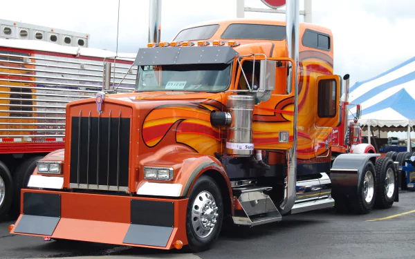 A vibrant orange Kenworth truck with flame decals, captured in sharp detail for a 4K Ultra HD PC desktop wallpaper and background.