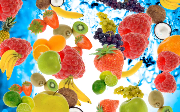 A vibrant HD wallpaper featuring an artistic arrangement of various fruits, including strawberries, bananas, and grapes, set against a refreshing blue background.