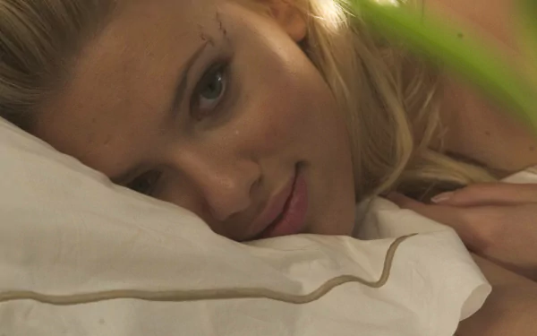 A close-up image of a woman lying on a pillow, smiling softly, featured in the movie Don Jon. This serves as an HD desktop wallpaper and background.