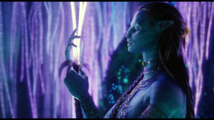 HD PC desktop wallpaper featuring a scene from the movie Avatar, showcasing a glowing, blue-skinned Na'vi character surrounded by bioluminescent flora.