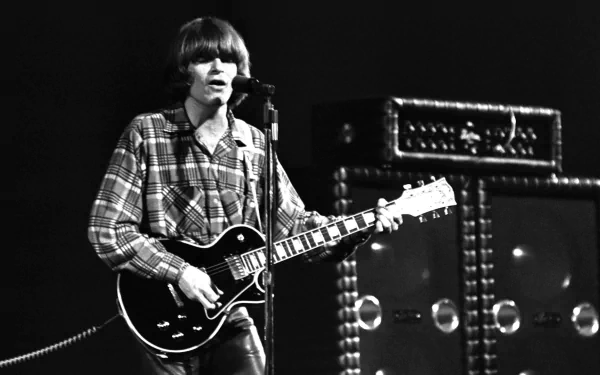 Black and white HD desktop wallpaper showing a Creedence Clearwater Revival musician playing guitar and singing on stage.