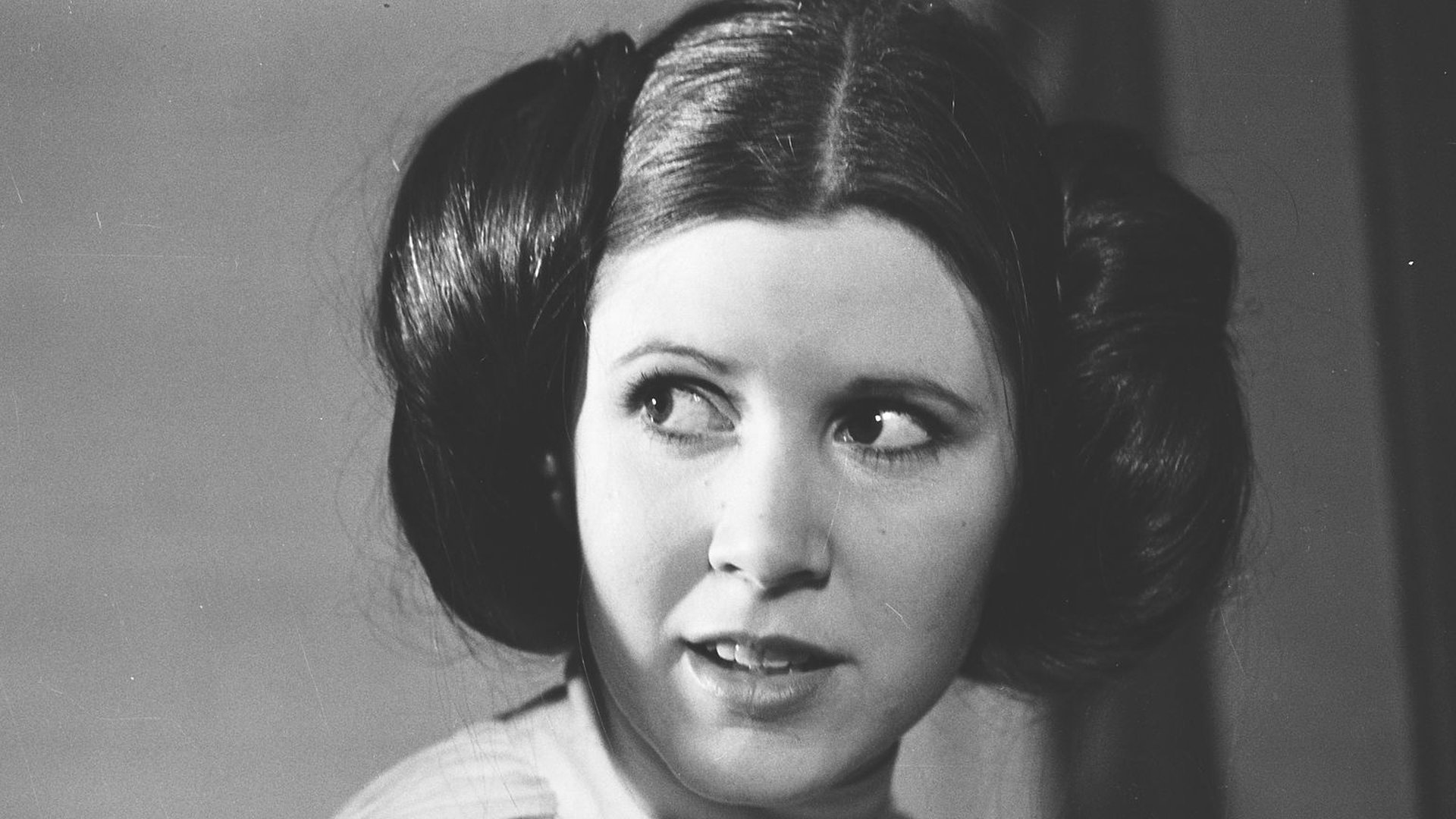 Black and white HD PC desktop wallpaper featuring a close-up of Princess Leia from the Star Wars movie, showcasing her iconic hairstyle and expression.