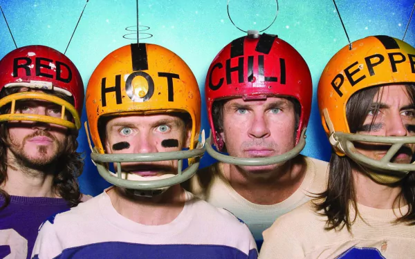 HD PC desktop wallpaper featuring the Red Hot Chili Peppers band members wearing colorful football helmets labeled with the band's name against a blue background.