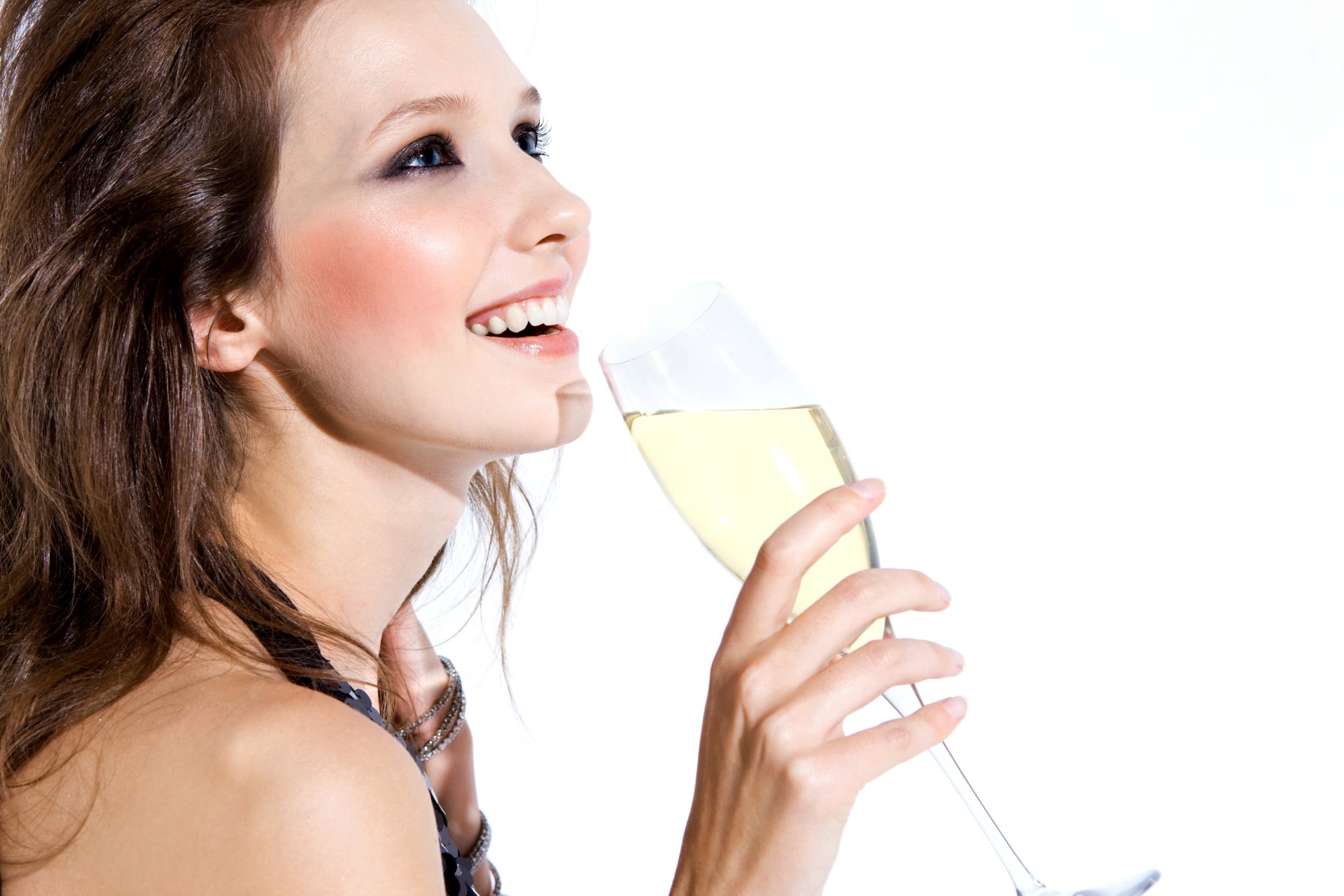 A joyful woman with long hair holds a glass of champagne, smiling brightly against a white background, creating an engaging 4K Ultra HD PC desktop wallpaper.