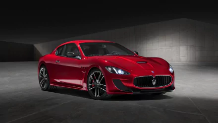 Sleek red Maserati GranTurismo showcased in a modern concrete setting, captured in 4K Ultra HD for a striking PC desktop wallpaper.