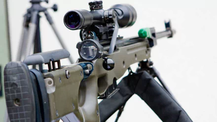 Close-up of a sniper rifle with a scope, showcasing detailed craftsmanship. This 4K Ultra HD image serves as an engaging desktop wallpaper and background for enthusiasts.