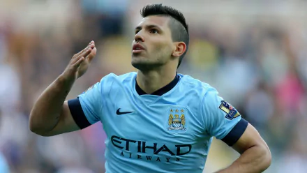 Sergio Agüero celebrates a goal while playing for Manchester City F.C., captured in this HD desktop wallpaper, showcasing his iconic blue kit and dynamic athleticism.