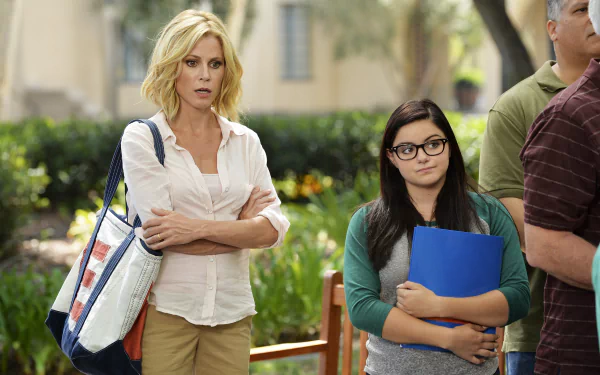 HD wallpaper from Modern Family featuring two characters standing side by side with a concerned expression.