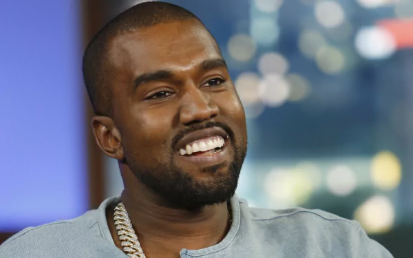 HD desktop wallpaper featuring a smiling man in a grey shirt with a blurred background.