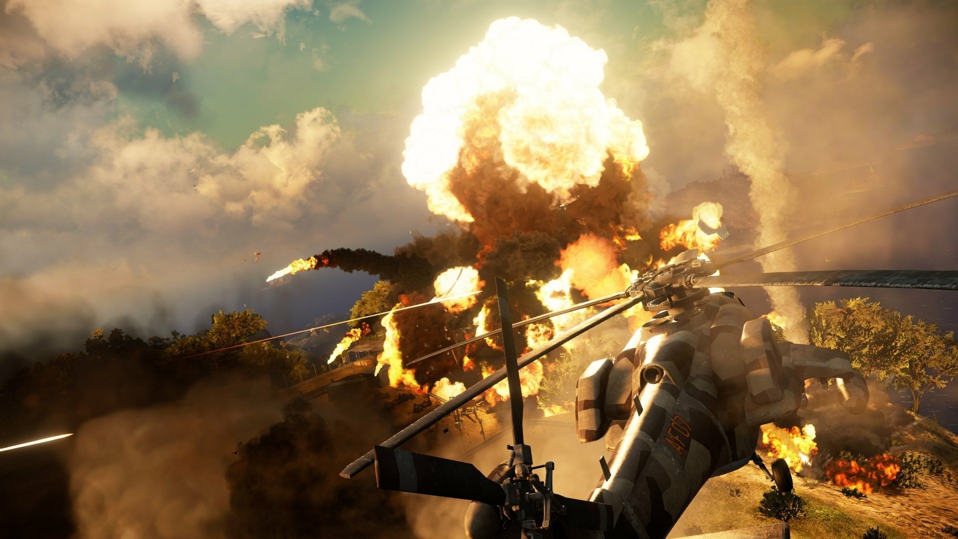 HD PC desktop wallpaper from the video game Just Cause 3, depicting a dramatic helicopter explosion with fiery clouds and a smoky battlefield.