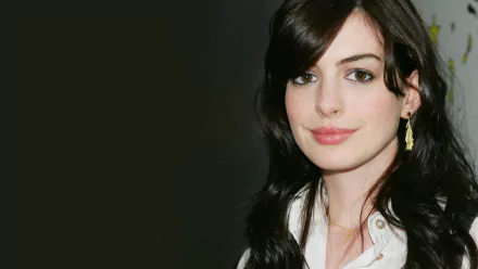 HD desktop wallpaper of Anne Hathaway wearing gold earrings, showcasing her face with dark hair against a dark background.