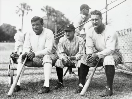 Three baseball players pose together on a grass field, showcasing a classic moment in sports history. This HD image serves as a vibrant desktop wallpaper for fans of baseball.