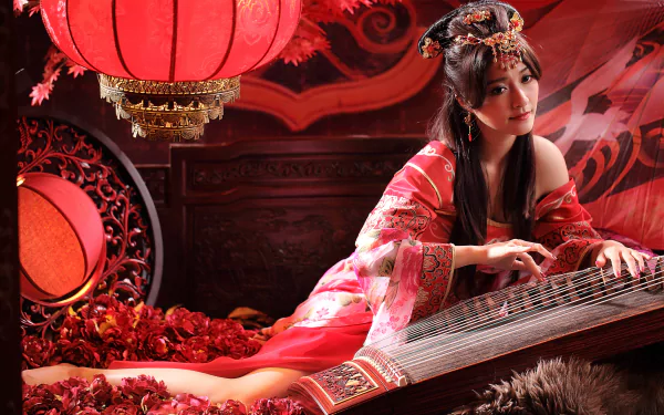 A woman in traditional Asian dress poses with a zither, surrounded by red lanterns and floral decor, creating an enchanting atmosphere in this vibrant 4K Ultra HD wallpaper.