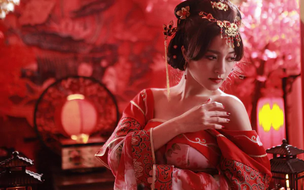 A woman in traditional Taiwanese national dress poses gracefully, adorned with a beautiful hairdo and surrounded by a warm, red ambiance with candles and lanterns.
