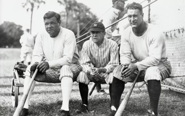 Three baseball players pose together on a grass field, showcasing a classic moment in sports history. This HD image serves as a vibrant desktop wallpaper for fans of baseball.