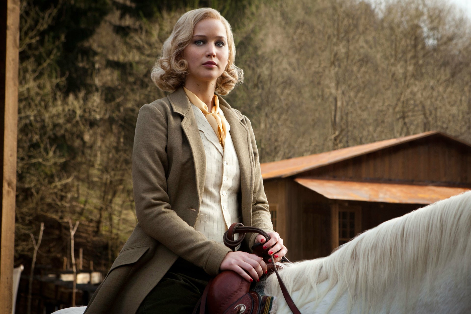 Jennifer Lawrence as Serena sitting on a white horse outdoors, featured in a 4K Ultra HD movie wallpaper background.