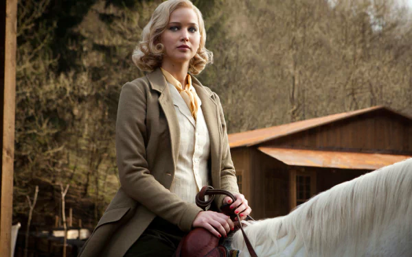 Jennifer Lawrence as Serena sitting on a white horse outdoors, featured in a 4K Ultra HD movie wallpaper background.