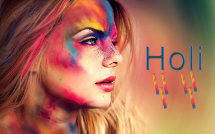 A vibrant close-up of a blonde woman with blue eyes, her face adorned with colorful powders celebrating Holi, features bold lipstick and artistic expression, creating a festive holiday atmosphere.