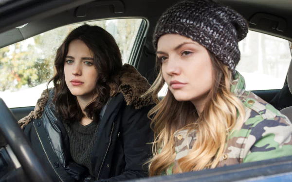 HD PC desktop wallpaper/background: scene from TV show The Leftovers — two women in winter coats and a knit hat sit in a parked car, staring ahead with serious, contemplative expressions.